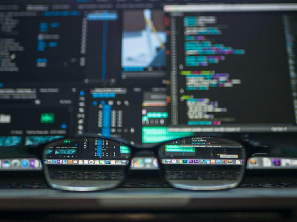 Top Website Development Strategies to Enhance User Experience and Boost Engagement 2025 Eyeglasses reflecting computer code on a monitor, ideal for technology and programming themes.